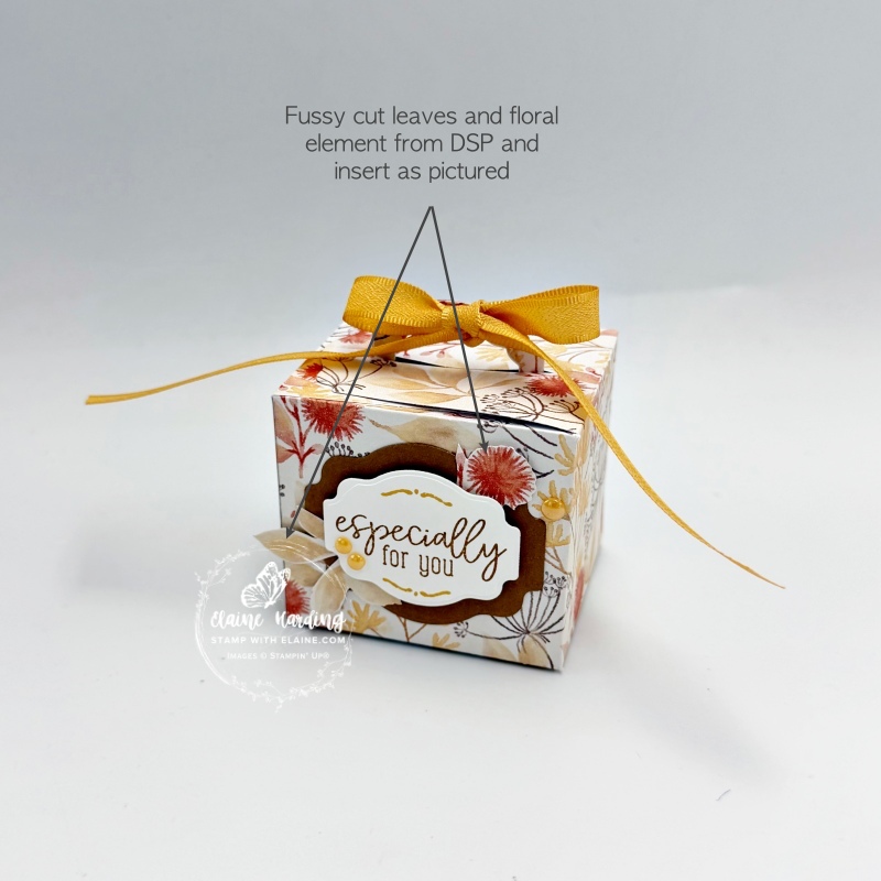 inserting fussy cut flowers under label